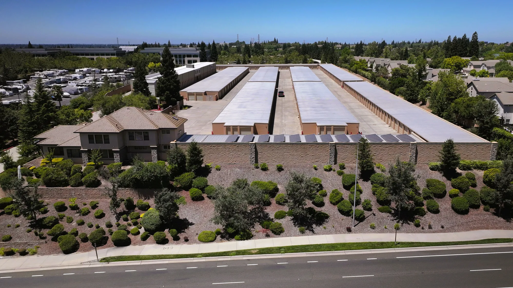 Aerial view of the Sierra College Self Storage office and terraced frontage, with solar panels covering the storage buildings behind it
