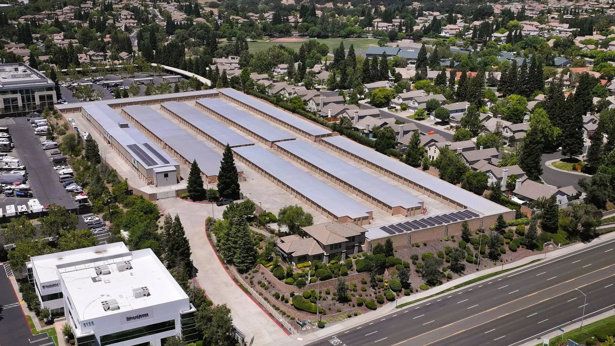 Aerial view of Sierra College Self Storage in Roseville, CA, its long rows of drive-up buildings running alongside Sierra College Boulevard